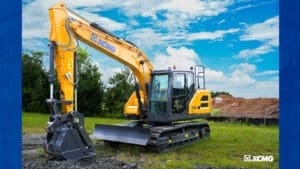 A construction site scene showing a yellow XCMG excavator digging, a wheel loader moving material, and a compact track loader, illustrating a diverse fleet.