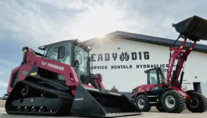 Yanmar TL100VS track loader and V10 wheel loader parked at ReadyDig dealership highlighting durable compact equipment.
