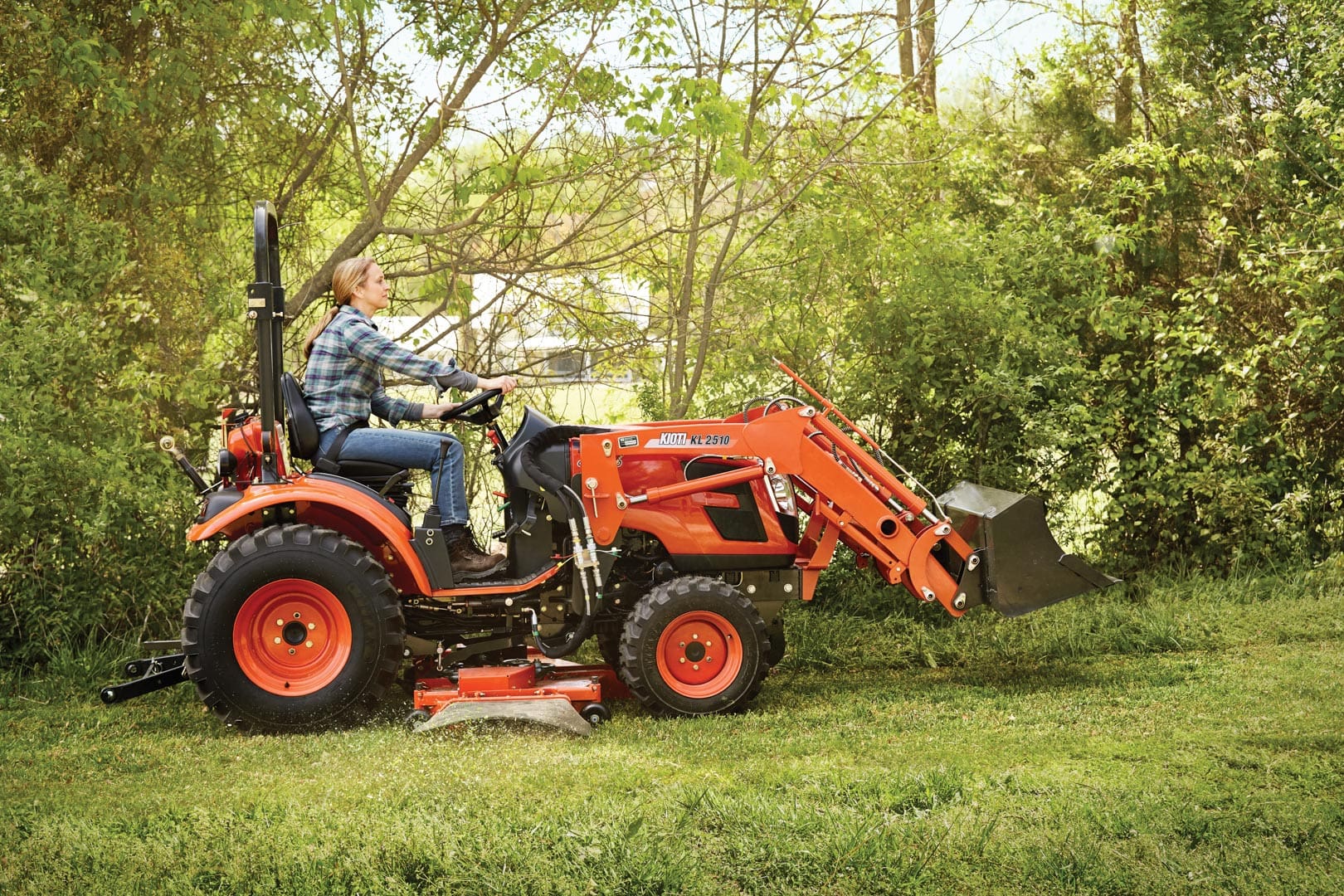 KIOTI CK tractor mowing on acreage